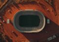 Lucid origin aerial photograph of a soccer stadium surrounded by dry red earth faded chalk li 0.jpg
