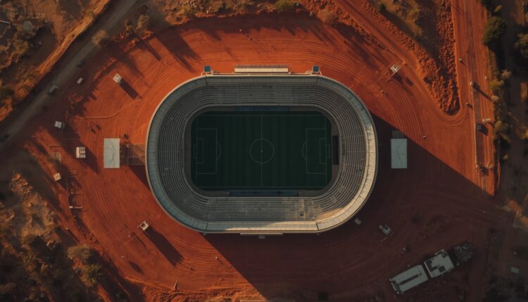 Lucid origin aerial photograph of a soccer stadium surrounded by dry red earth faded chalk li 0.jpg